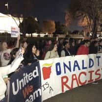 Anti-Trump protest with Trump is racist sign