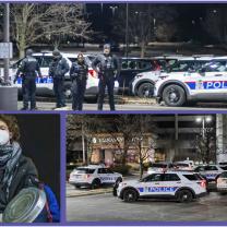 Police cars and officers at protest