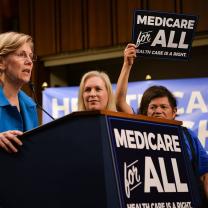 Elizabeth Wareen speaking at podium about Medicare for All